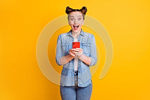 Photo of funny teen lady two buns look interested telephone read positive nice good comments blog open mouth overjoyed