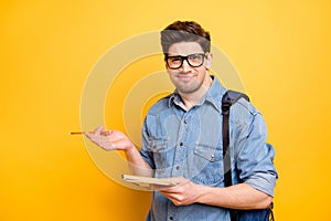 Photo of funny uncertain thinking man in denim shirt expressing misunderstanding on her face unable to understand