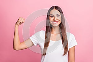 Photo of funny young brunette lady show muscle wear white t-shirt isolated on pink color background