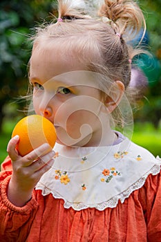 Photo of a girl in the garden among fruit trees