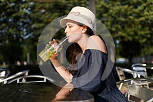 Photo of girl in hat with glass