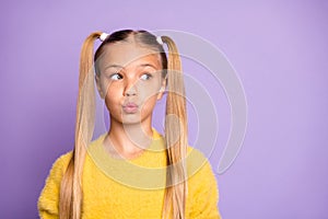 Photo of girl looking into empty space with her lips pouted  pastel violet color background