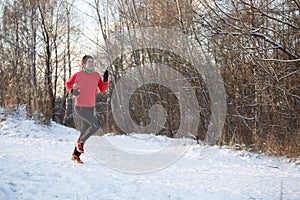 Photo of girl in sports uniform on morning run in winter forest