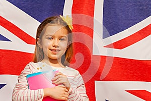 Photo of girl with textbooks against English flag