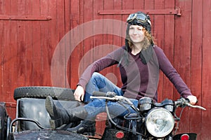 Photo of girl on a vintage motorbike in pilot cap