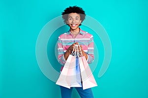Photo of glad positive cheerful man wear stylish clothes hold packages store mall center isolated on cyan color