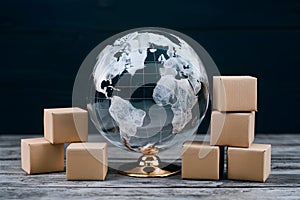 Photo Glass globe and boxes, global business and distribution concept