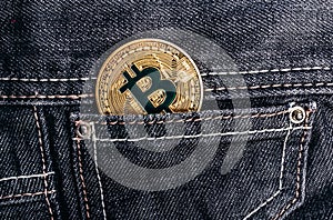 Photo of gold bitcoin on a back denim pants pocket