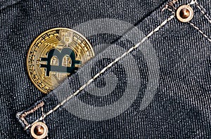 Photo of gold bitcoin on a back denim pants pocket