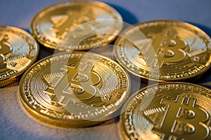 Photo Golden Bitcoins On Blue Background. Trading Concept Of Crypto Currency