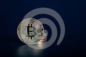 Photo Golden Bitcoins On dark background. Trading Concept Of Crypto Currency