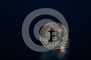 Photo Golden Bitcoins On dark background. Trading Concept Of Crypto Currency