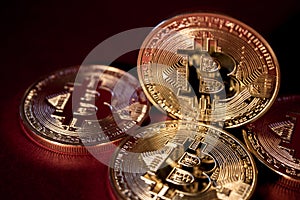 Photo Golden Bitcoins On Red Background. Trading Concept Of Crypto Currency