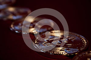 Photo Golden Bitcoins On Red Background. Trading Concept Of Crypto Currency