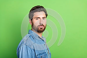 Photo of good mood attractive guy wear denim jacket smiling empty space  green color background