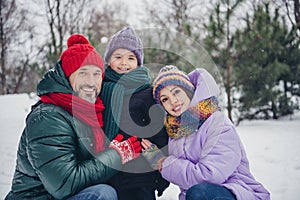 Photo of good mood cheerful little child wife husband dressed coats cuddling together outdoors urban forest park