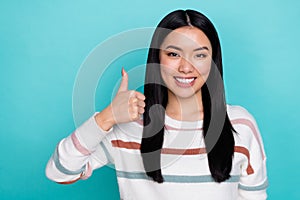 Photo of good mood korean girl showing thumb-up promote you product isolated on teal color background