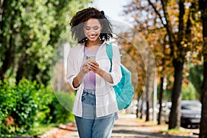 Photo of good mood pretty lady wear white shirt rucksack travelling watching route modern gadget app outside urban city