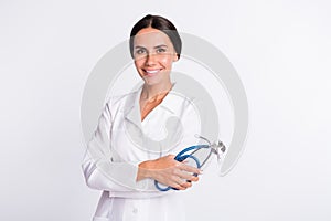 Photo of good mood pretty young lady physician dressed uniform smiling holding stethoscope isolated white color