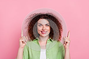 Photo of good mood woman with perming coiffure dressed stylish shirt look directing at sale empty space isolated on pink