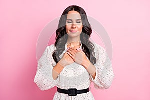 Photo of gorgeous positive girl closed eyes arms on chest wear retro outfit  on pink color background