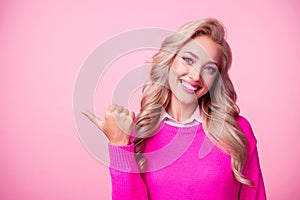 Photo of gorgeous stunning girl wear stylish pullover thumb demonstrate special offer empy space isolated on pink color