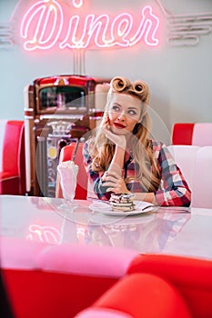 Photo of gorgeous woman eating pancakes and drinking milkshake