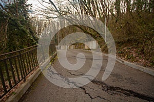 Photo of gray cracked asphalt pavement