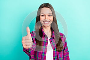 Photo of greatful long hairdo millennial lady show thumb up wear checkered shirt isolated on vivid teal color background