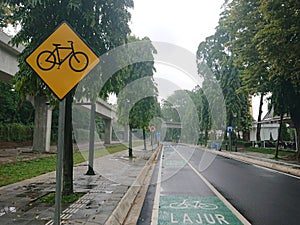 Green bicycle track and road sign in indonesia language, jalur sepeda photo