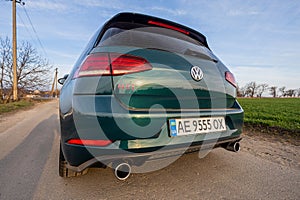 Photo of green car Volkswagen Golf GTI on the street