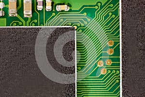 Photo of a green electrical circuit connecting two electronic components.