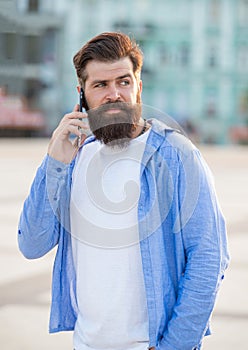 photo of guy speak on smartphone, answerphone. guy speak on smartphone outdoor