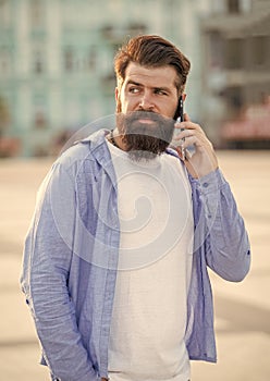 photo of guy speak on smartphone, answerphone. guy speak on smartphone outdoor