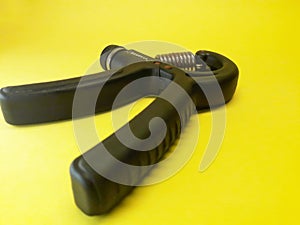 Photo of a handgrip sports equipment with a yellow background