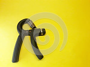 Photo of a handgrip sports equipment with a yellow background