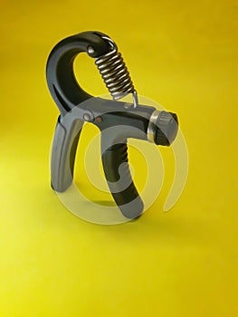 Photo of a handgrip sports equipment with a yellow background