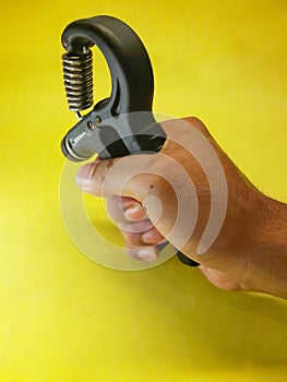 Photo of a handgrip sports equipment with a yellow background