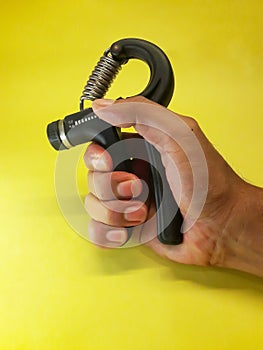 Photo of a handgrip sports equipment with a yellow background