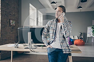 Photo of handsome business administrator guy leaning table self-confident person talking telephone with partners wear
