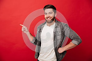 Photo of handsome cheerful man 30s in jeans jacket gesturing fin