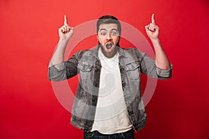 Photo of handsome cheerful man 30s in jeans jacket gesturing fin