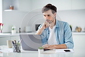 Photo of handsome guy businessman confident person browsing notebook sitting table desktop video call teacher work house