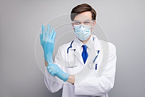 Photo of handsome serious doc guy professional surgeon specialist preparing operation wear gloves facial protective mask