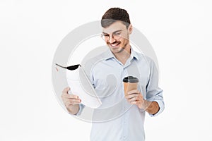 Photo of happy caucasian man drinking coffee and reading magazine