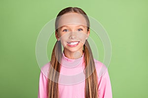 Photo of happy charming cheerful little girl smile good mood casual clothes isolated on red color background