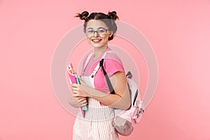 Photo of happy charming girl posing with exercise books and smiling