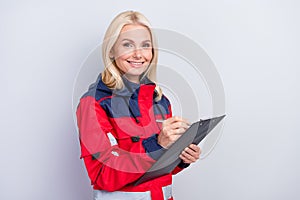Photo of happy charming positive old woman hold clipboard write good mood job isolated on grey color background