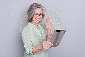Photo of happy cheerful businesswoman having video call with boos saying hello isolated on grey color background