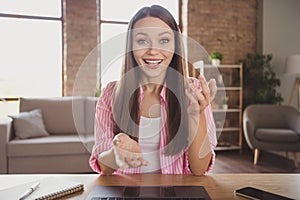 Photo of happy cheerful young woman speak web camera remote meeting internet seminar indoors inside house office